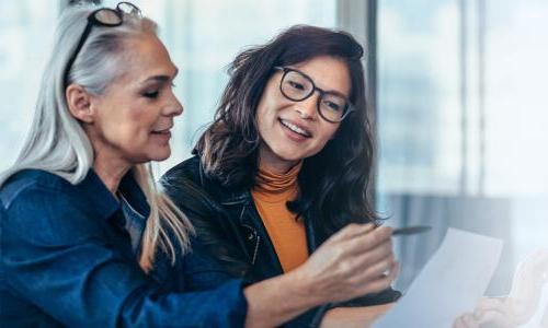 Women business analysts reviewing data in reports