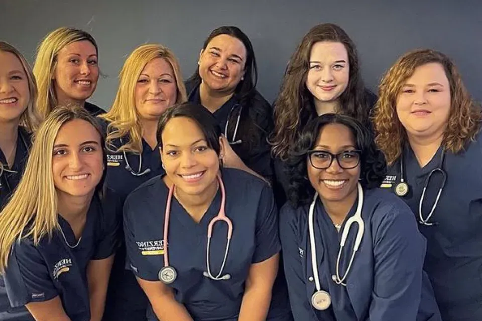 Group of nursing students in scrubs smiling